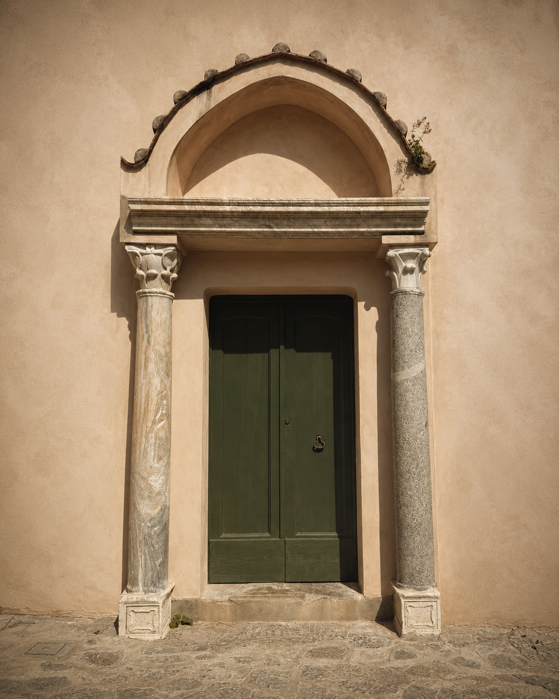 A green door set between carved marble columns — the quieter days that follow the wedding.